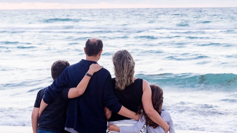 a family of four on a beach