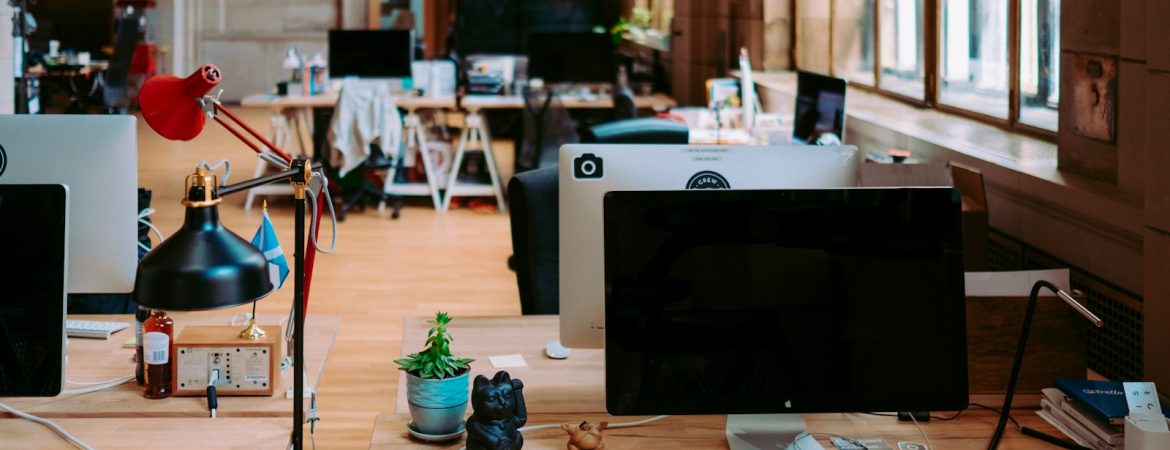 black flat screen computer monitor on brown wooden table