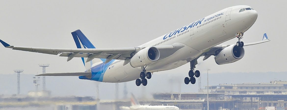 white and blue airplane about to fly at the airport